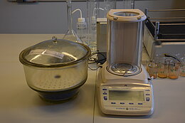 Silica gel desiccator (left), high precision balance (right).
